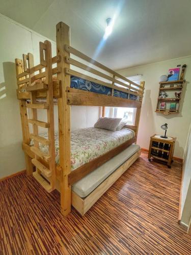 a bedroom with a bunk bed with a ladder at Casa Natales - Dormitorio Privado in Puerto Natales