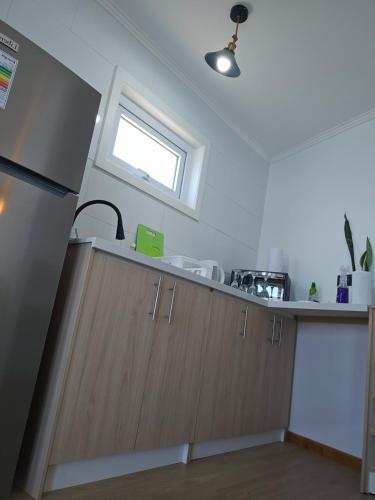 a kitchen with a counter top and a window at Santorini in Quintero
