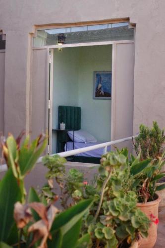 a room with a balcony with plants and a mirror at Dar Chamss in Taroudant