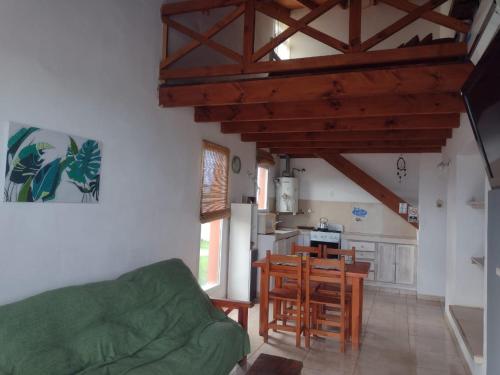 a living room with a table and a kitchen at HUAYCAMAR in Playa Dorada