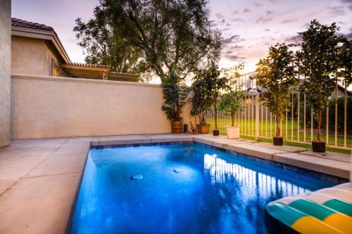 a swimming pool in the backyard of a house at Music Lovers Paradise 7 Bed Pool Home and Game Room in Indio