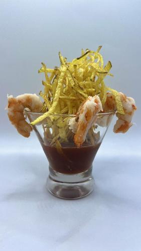 a bowl of food with shrimp and french fries at Akwaba Lodge in The Gap