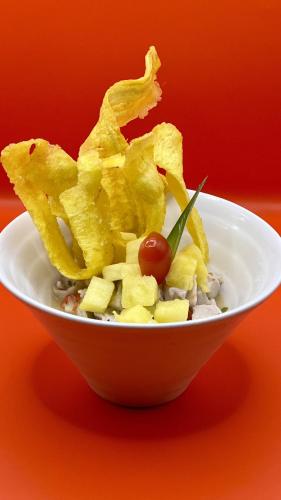 a white bowl filled with chips and a cherry tomato at Akwaba Lodge in The Gap