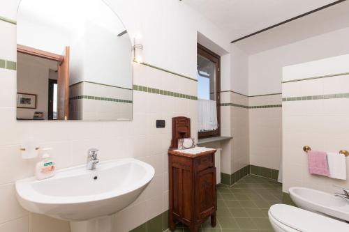 a bathroom with a sink and a mirror at C dra Topia the Grape Pergola House near Alba Charming house - Italy in Trezzo Tinella