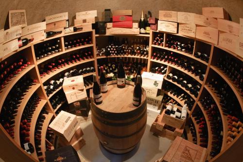 a bunch of wine bottles in a wine cellar at Donna Carmela Resort & Lodges in Riposto