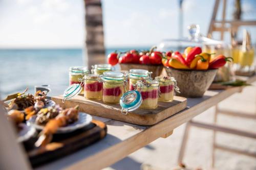 a table with jars of jam and a plate of food at Renaissance Wind Creek Aruba Resort in Oranjestad