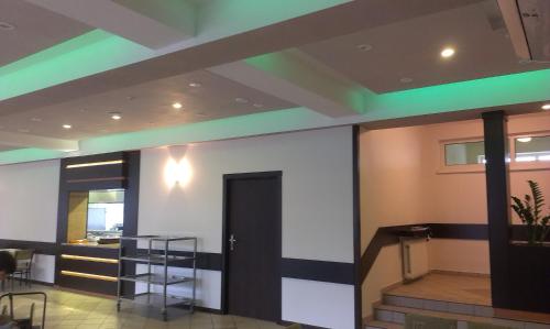 a lobby with a door and a green stripe on the ceiling at HOTEL ODR in Sulechów