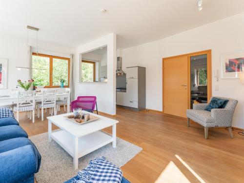 a living room with a blue couch and a table at Bachwinkl in Maria Alm am Steinernen Meer