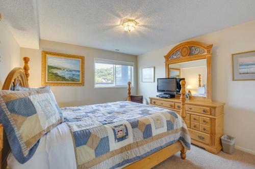 a bedroom with a bed and a dresser and a television at Lincoln City Oceanfront Condo, Near Lincoln Beach! in Lincoln City