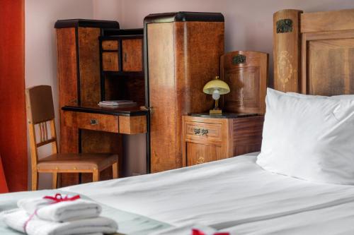 a bedroom with a bed and a table and a chair at Chopin Boutique in Warsaw