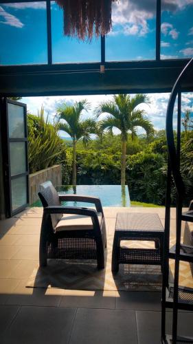 a patio with two chairs and a view of a pool at Ecoparadise Hotel in Pereira