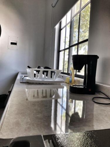 a kitchen with a counter top with a coffee maker at 11 Suite Grande Para 4 Personas con Factura in Torreón
