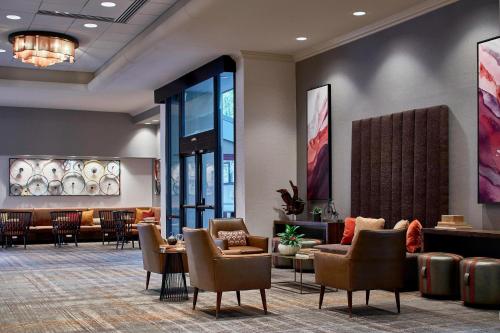 a lobby of a hotel with chairs and tables at Renaissance Asheville Downtown Hotel in Asheville