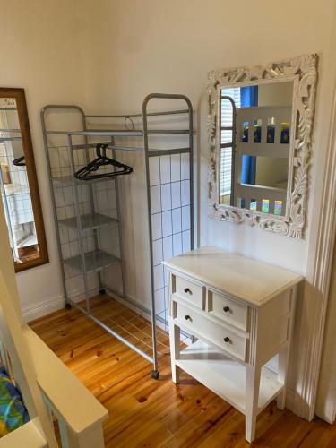 a bedroom with a dresser and a mirror and a shelf at Banksia Views in Sandy Point