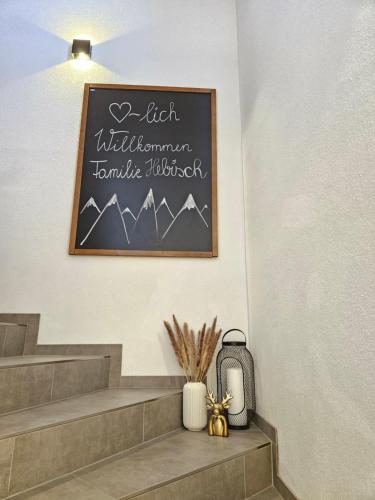 a chalkboard sign on the wall of a stairwell at Apart Alpenflair in Umhausen