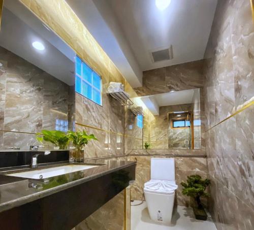 a bathroom with a sink and a toilet at Lanna Tree Boutique Hotel in Chiang Mai