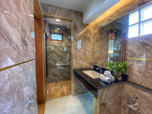 a bathroom with a sink and a shower at Lanna Tree Boutique Hotel in Chiang Mai