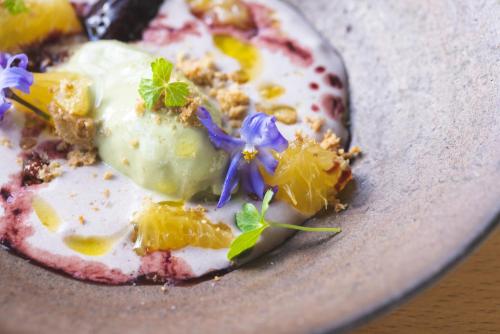 a plate of food with a dessert with flowers on it at awai 戸隠 in Nagano