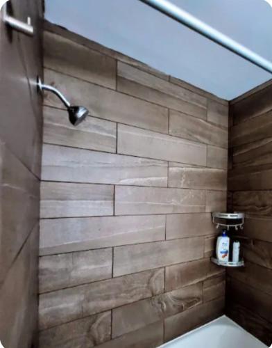 a shower with a stone wall in a bathroom at Cozy House in Long Pond 3 bedrooms 10 people in Long Pond