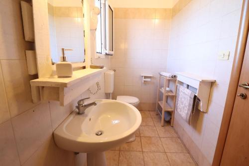 a white bathroom with a sink and a toilet at Casa Regina Residence Torre Santo Stefano in Otranto 3 places in Alimini