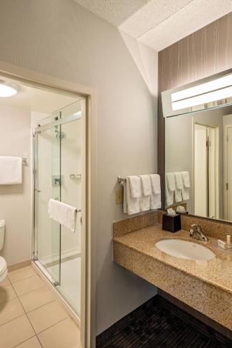 a bathroom with a sink and a shower at Courtyard Cincinnati Blue Ash in Blue Ash