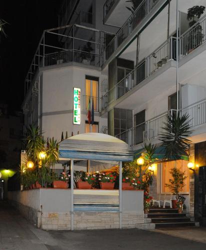 a hotel at night with a sign in front of it at Hotel Sorriso in Sanremo
