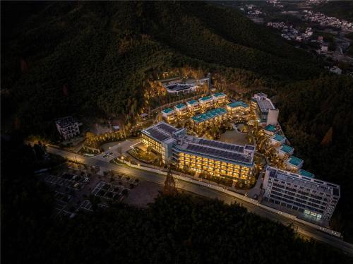 an overhead view of a city at night with lights at Yibo Jinling Hotel Moganshan in Huzhou