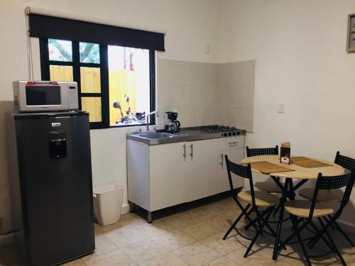 a small kitchen with a table and a microwave at Department, Studio Type Excellent Location in Mexico City