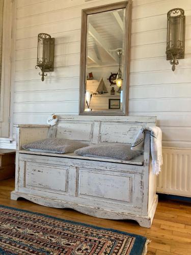 a mirror on top of a bed in a room at 6 pers House Marijke with winter garden and direct access to the Lauwersmeer in Anjum