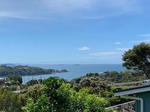 a view of the ocean from a house at The Garden Room by Waiheke Pure in Waiheke Island