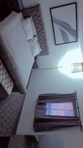 a table with a lamp on top of a room at D'Chin Dorcelle Suite in Norbury