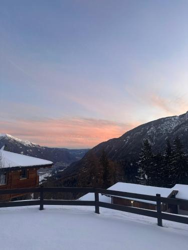 a snow covered balcony with a view of a mountain at Kymera Alpine Apartment in Folgarida
