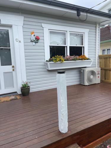a house with a deck with a window at Manley St Suite in Redcliffe