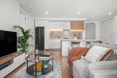a living room with a couch and a table at 2B2B Luxury at Flagstaff Gardens with Parking in Melbourne