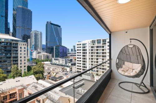 a balcony with a chair and a view of the city at 2B2B Luxury at Flagstaff Gardens with Parking in Melbourne