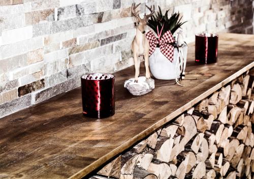 a table with a reindeer and three cups on it at Hotel Lärchenhof in Kaunertal