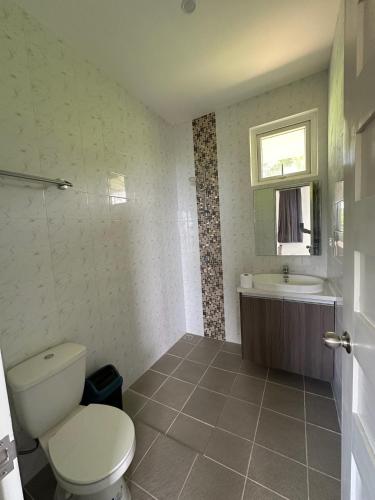 a bathroom with a toilet and a sink at Assaly Villa - Breathtaking Ocean View with private beach in San Jose