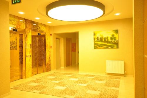a hallway with a ceiling with a painting and a rug at Bupa Hotel in Kayseri