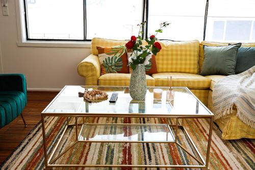 a living room with a couch and a glass coffee table at StayAU Family-Friendly 3BR Getaway in Malvern in Chadstone