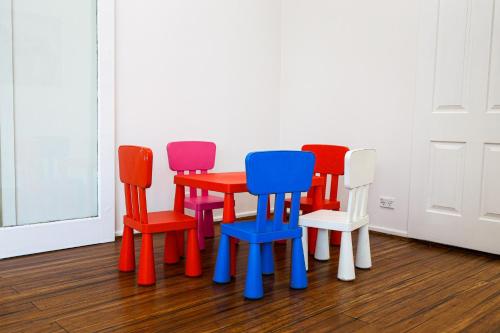 a group of colorful chairs sitting in a room at StayAU Family-Friendly 3BR Getaway in Malvern in Chadstone