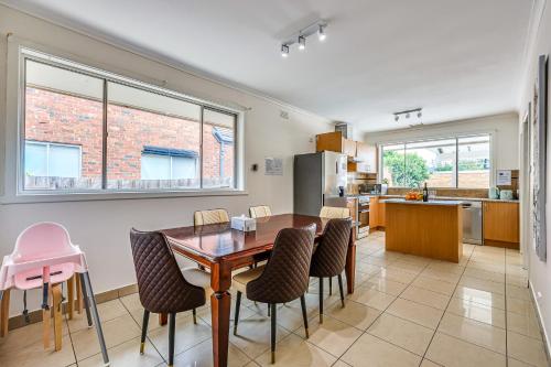 a kitchen and dining room with a table and chairs at StayAU Family-Friendly 3BR Getaway in Malvern in Chadstone