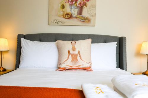 a bedroom with a bed with a meditation pillow on it at StayAU Family-Friendly 3BR Getaway in Malvern in Chadstone