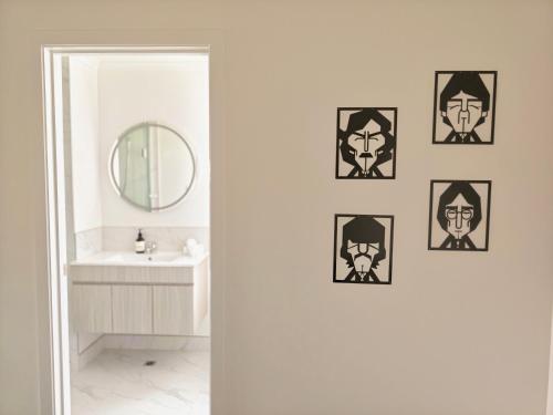 a bathroom with a mirror and a sink at New Built Gem in Hillcrest in Hamilton