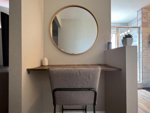 a mirror on a wall above a table with a chair at Private Home - Billiards, Mountain Views, Private Desert Access, HOA Pool & Spa, BBQ, at Lambert Park - Bourbondale in Tucson