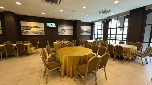 a conference room with tables and chairs in it at The Grand Puteri Hotel in Kuala Terengganu