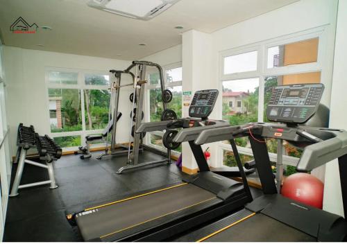 a gym with two tread machines and a treadmill at Palawan Luxury 2BR Condo with Pool, Gym & Parking - B1 5Kunzite in Puerto Princesa City