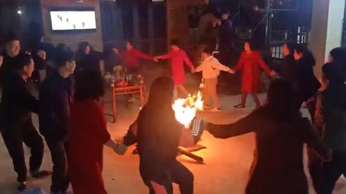 a group of people dancing around a fire at Viena Homestay in Bắc Hà