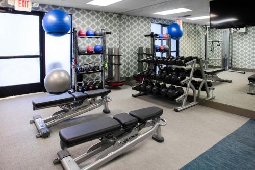 a gym with dumbbells and weights in a room at Aloft Nashville West End in Nashville