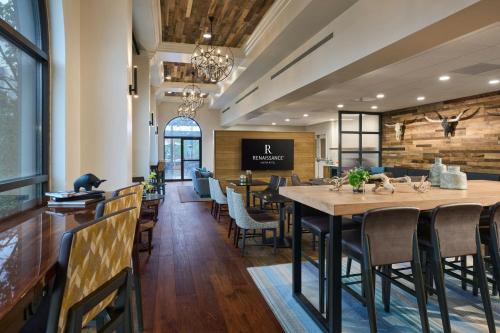 a dining room with a large table and chairs at Renaissance Austin Hotel in Austin
