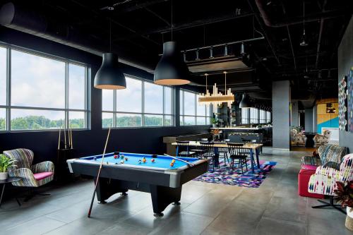 a billiard room with a pool table in it at Aloft Chattanooga Hamilton Place in Chattanooga